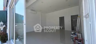 Spacious modern room with sleek tile flooring and air conditioning unit