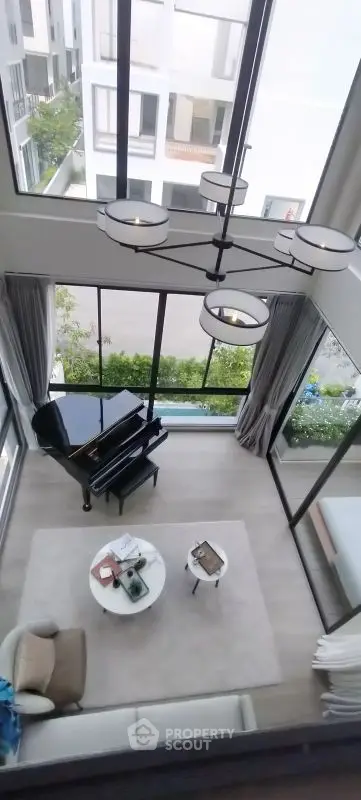 Stunning double-height living room with large windows and elegant decor