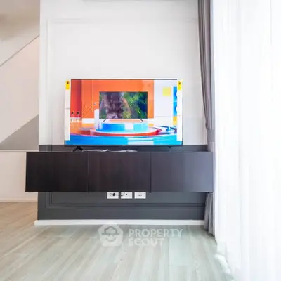 Modern living room with sleek wall-mounted TV and stylish decor