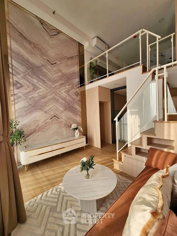 Luxurious modern living room with high ceiling and mezzanine, featuring elegant decor and natural light.