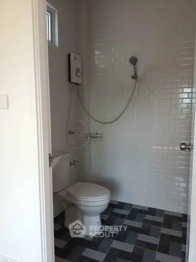 Modern bathroom with sleek tiles and shower, perfect for a minimalist home.