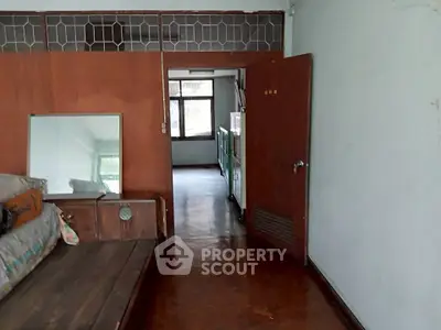 Spacious interior with wooden accents and natural light, ideal for renovation.