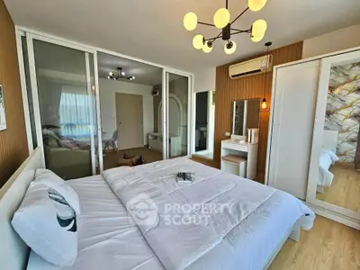 Modern bedroom with stylish decor, featuring a cozy bed, elegant lighting, and a spacious wardrobe.