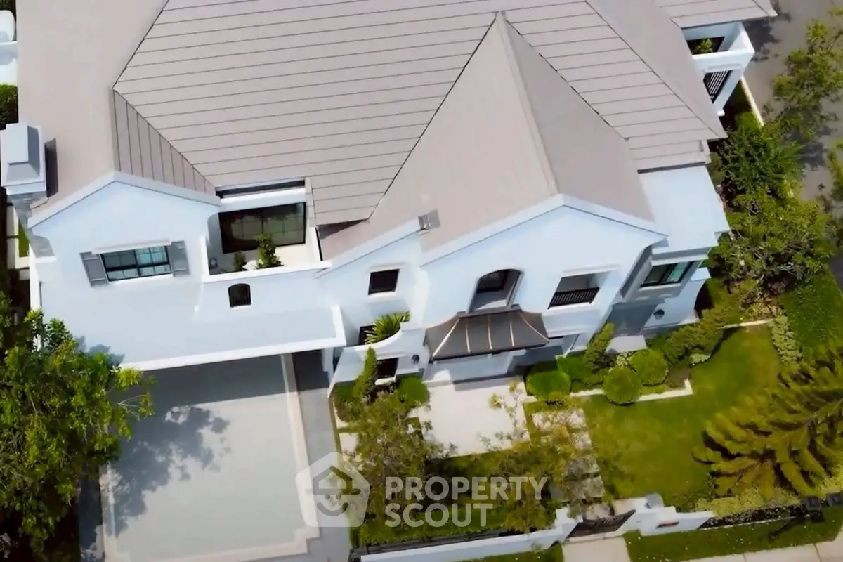 Stunning aerial view of a modern luxury home with sleek architecture and lush landscaping.