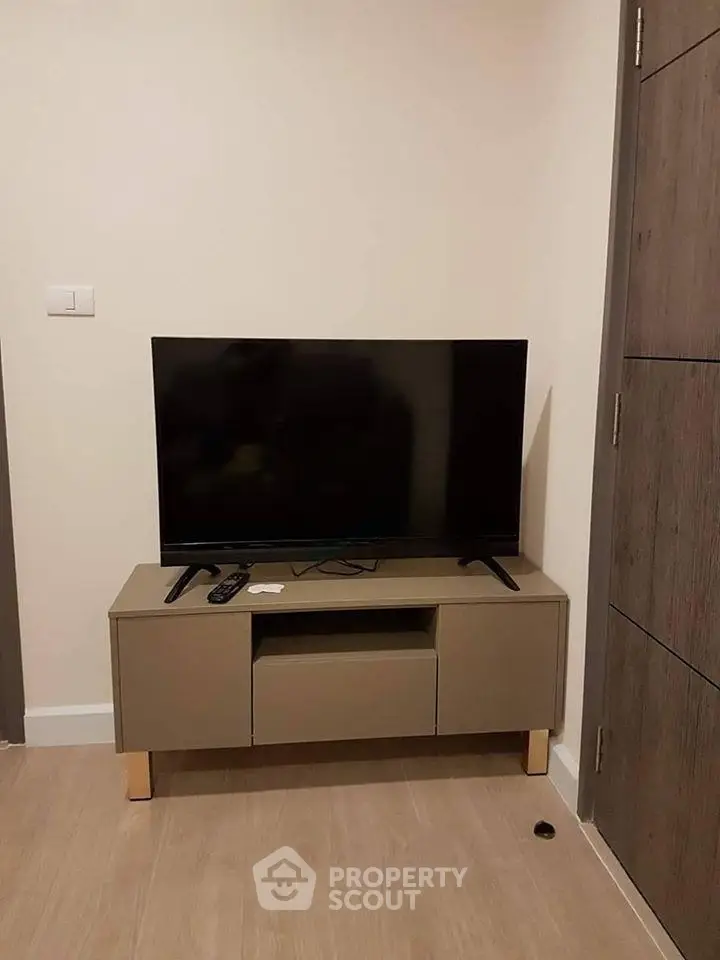 Modern living room with sleek TV stand and flat-screen TV, perfect for cozy entertainment.
