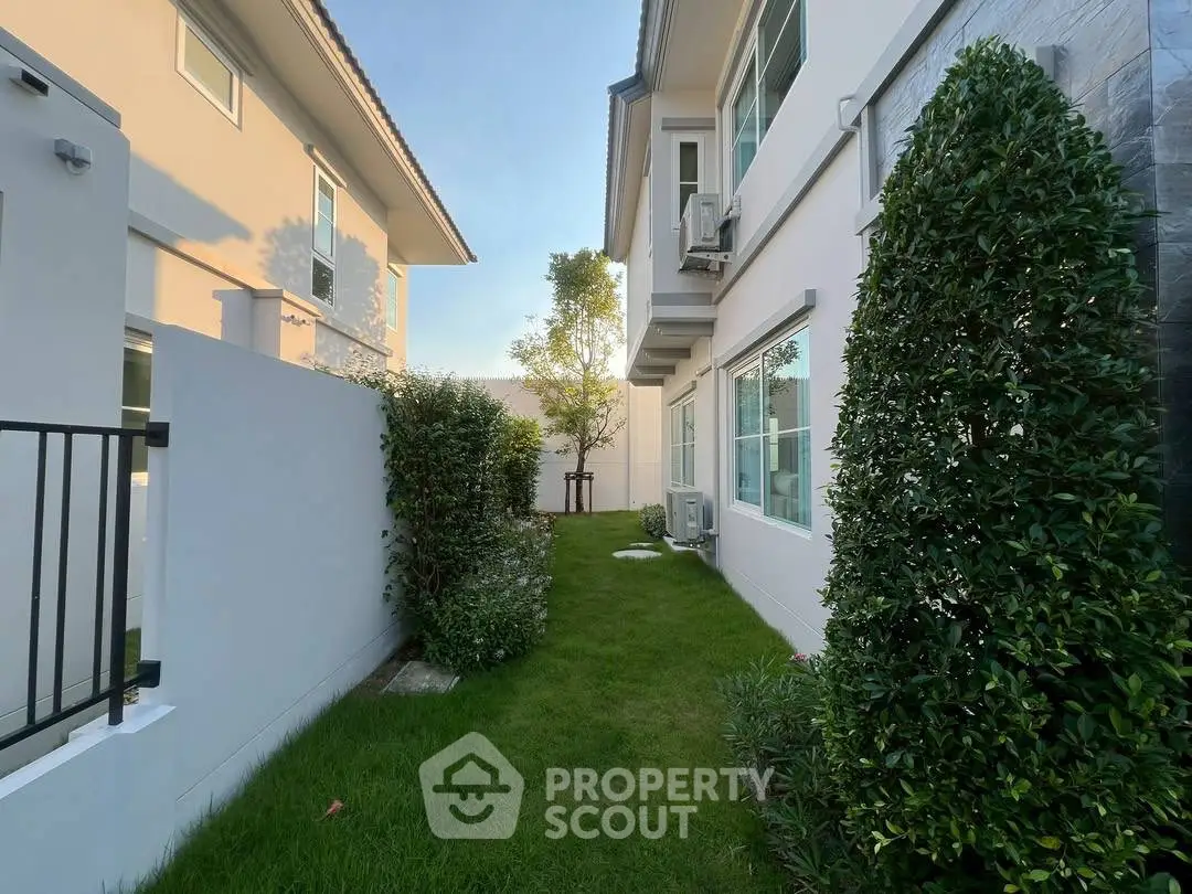 Charming suburban home exterior with lush green garden and modern architecture.