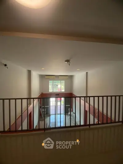 Spacious two-story interior with high ceilings and large windows, ideal for modern living.