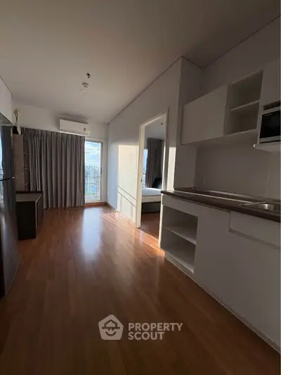 Modern apartment interior with open kitchen and wooden flooring