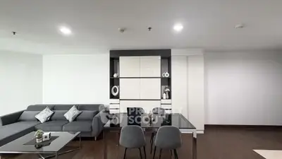 Modern living room with sleek furniture and elegant decor in a spacious apartment.