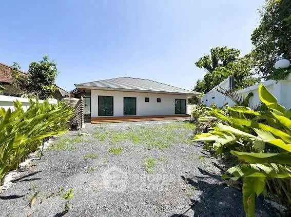 Charming single-story home with spacious front yard and lush greenery, perfect for family living.