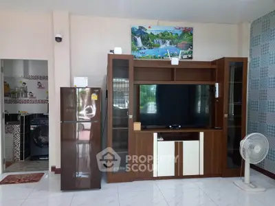 Spacious living room with modern entertainment center and appliances