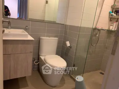 Modern bathroom with sleek fixtures and glass shower enclosure