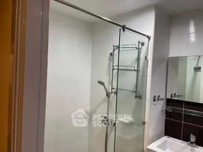 Modern bathroom with glass shower door and sleek fixtures
