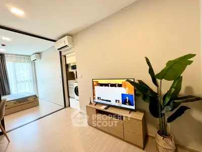Modern apartment interior with living room, bedroom, and kitchen featuring sleek design and natural light.