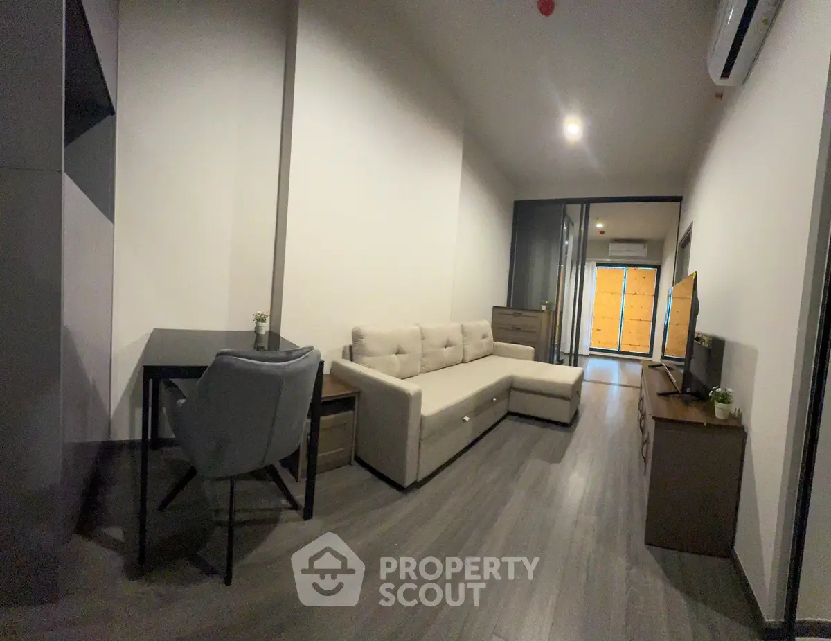 Modern living room with sleek furniture and open layout, perfect for urban living.