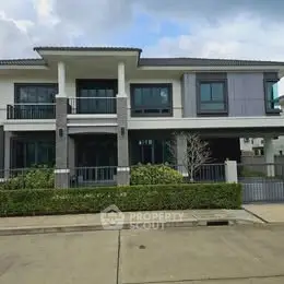 Modern two-story house with sleek design and spacious balcony, perfect for family living.