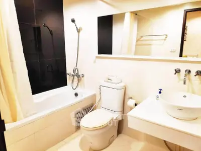 Modern bathroom with sleek fixtures and a bathtub in a stylish real estate property.