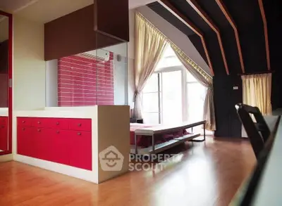 Spacious bedroom with modern design and large windows for natural light.