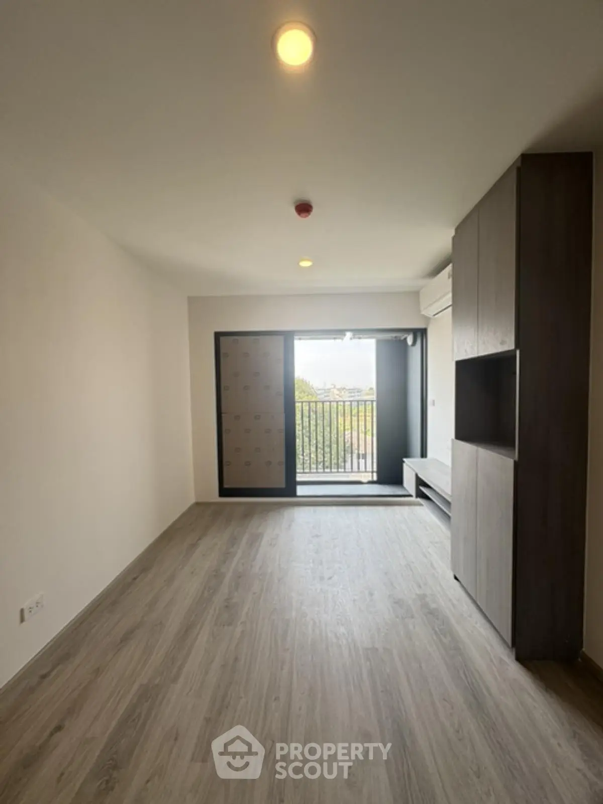 Modern living room with balcony and sleek wooden flooring