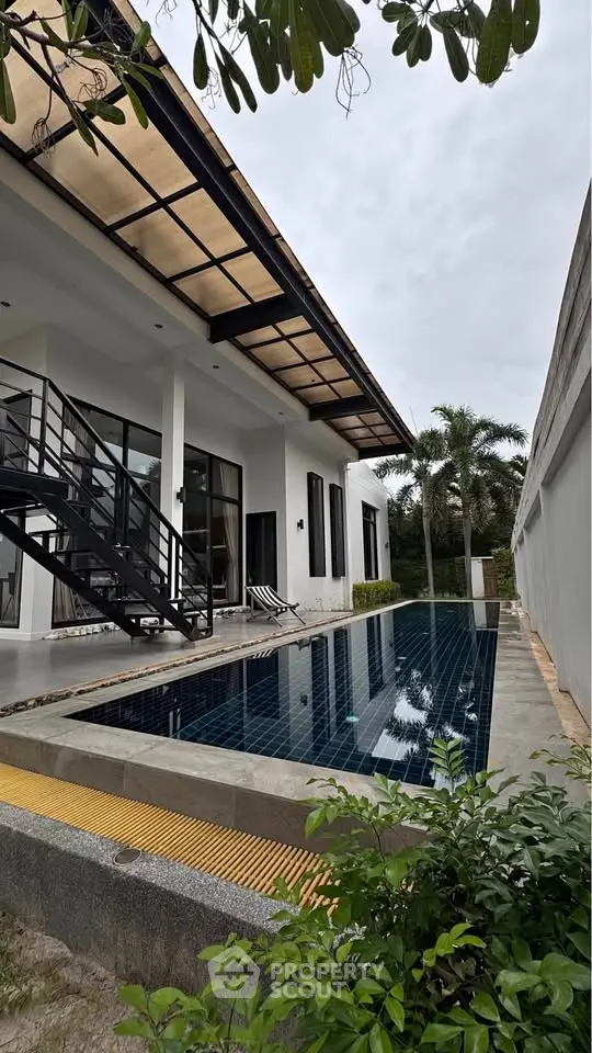 Modern villa with private pool and sleek architecture in tropical setting.