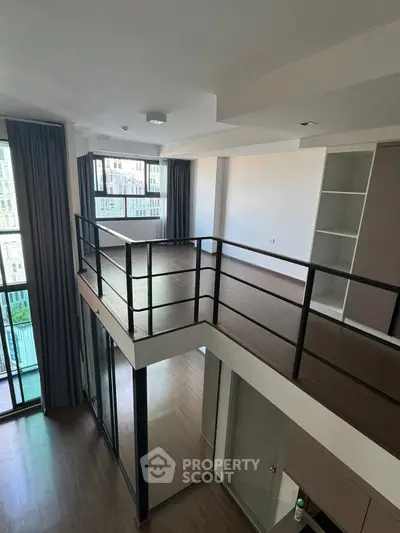 Modern duplex apartment with high ceilings and large windows offering ample natural light.