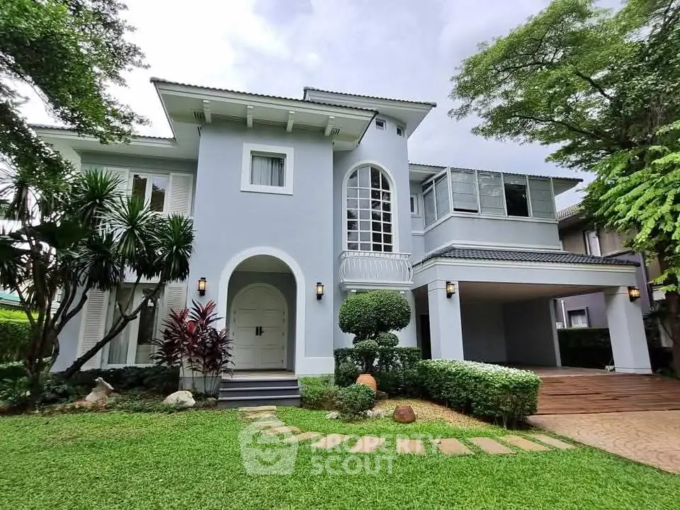 Elegant two-story house with lush garden and spacious driveway