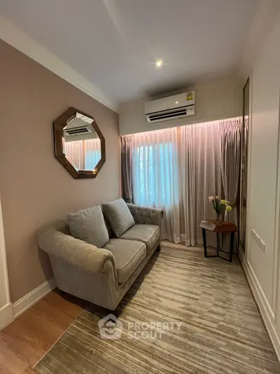 Cozy living room with elegant sofa and stylish decor, perfect for relaxation.