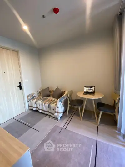 Cozy living room with modern decor and small dining area, perfect for urban living.