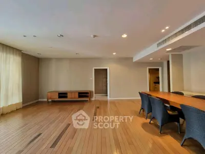 Spacious living room with elegant wooden flooring and modern dining area