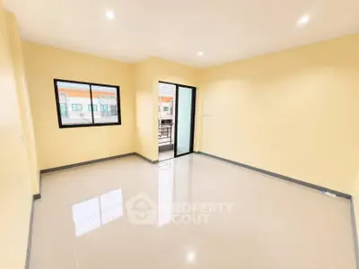 Spacious unfurnished room with large windows and glossy tiled floor, perfect for customization.