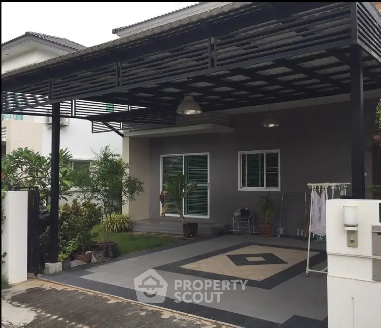 Modern house exterior with covered carport and landscaped garden