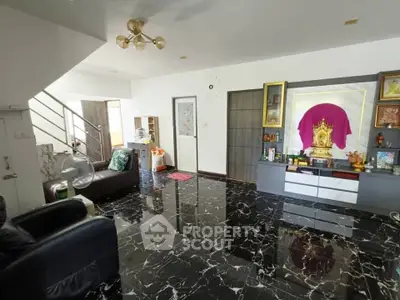 Spacious living room with elegant black marble flooring and modern decor