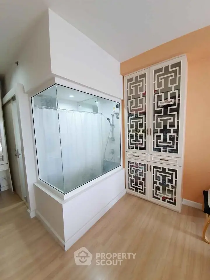 Modern bathroom with glass shower enclosure and stylish storage cabinet