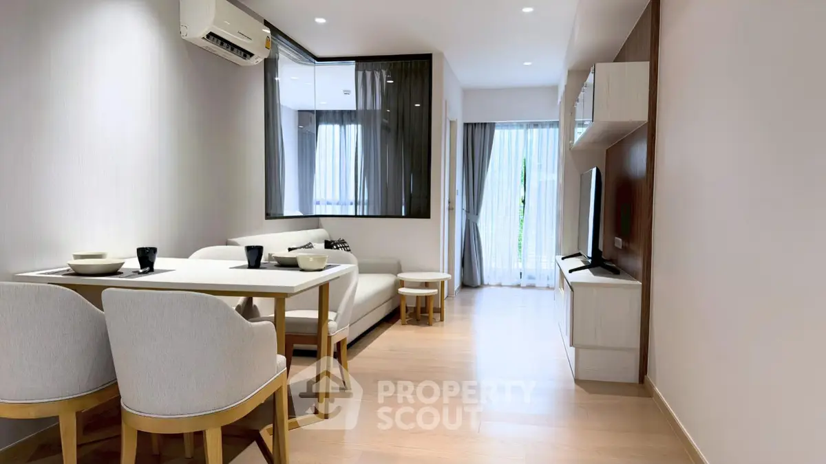 Modern living room with sleek furniture and natural light, perfect for cozy gatherings.