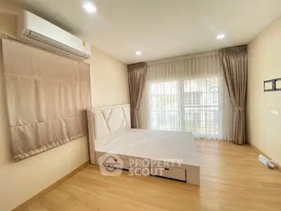 Spacious bedroom with modern design and large window for natural light