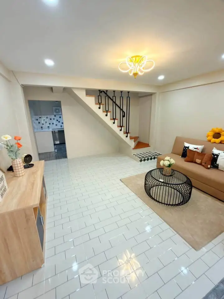 Modern living room with stylish decor and staircase in a cozy home interior.