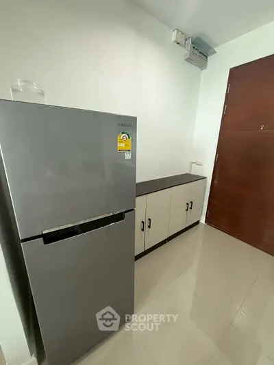 Modern kitchen with sleek refrigerator and ample storage cabinets