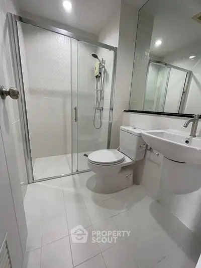 Modern bathroom with glass shower and sleek fixtures