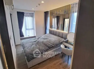 Modern bedroom with stylish decor and large windows for natural light