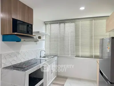 Modern kitchen with sleek design, featuring built-in appliances and stylish cabinetry.