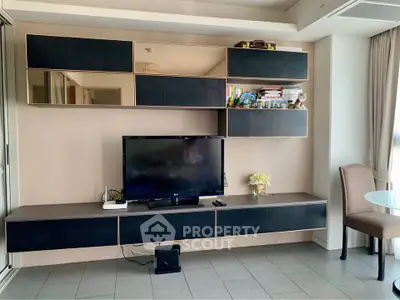 Modern living room with sleek TV unit and stylish decor in a contemporary apartment.