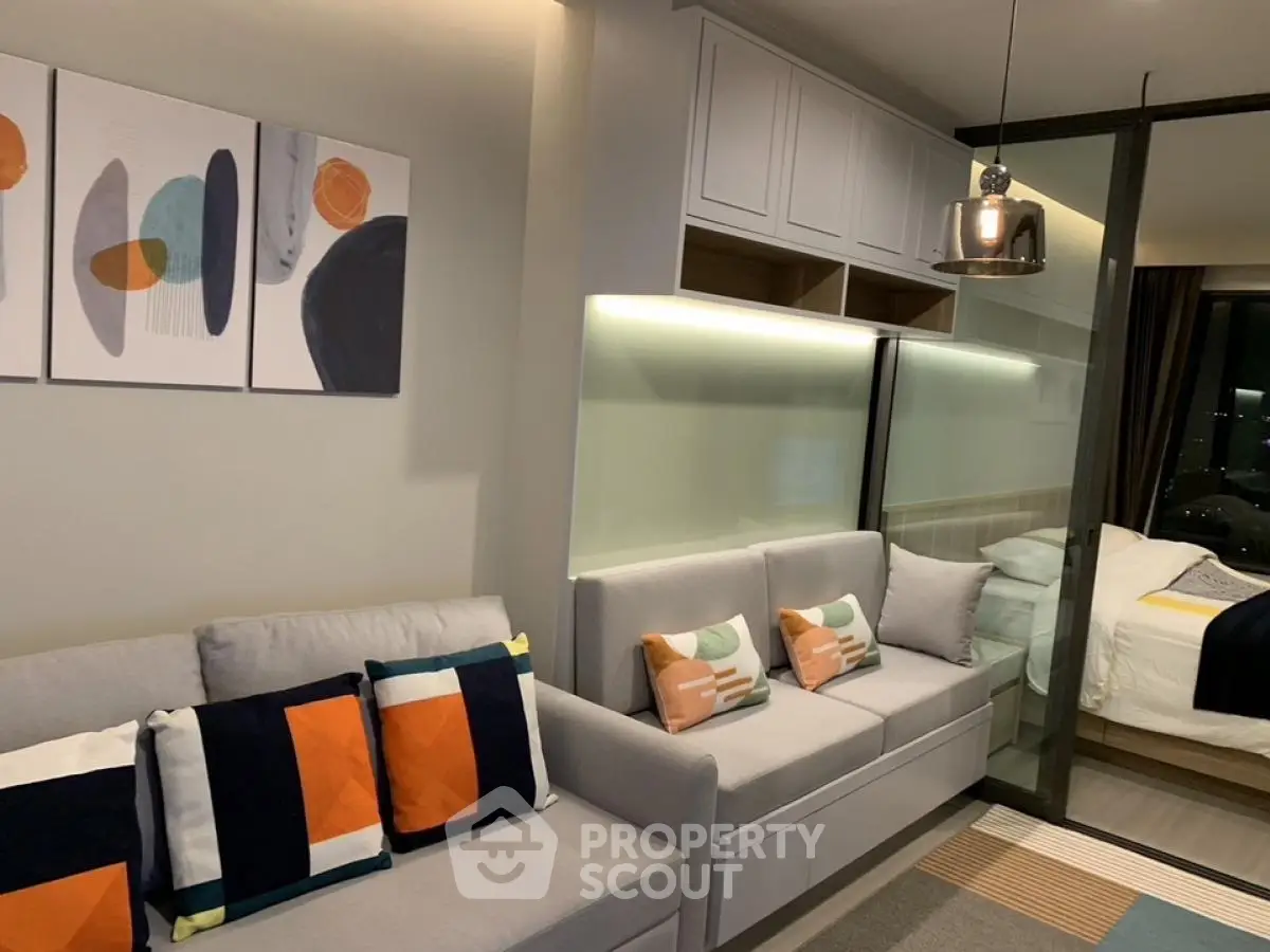 Modern living room with stylish decor and cozy seating in a contemporary apartment.