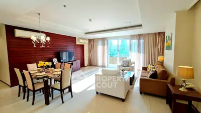 Spacious and elegantly furnished living room with dining area and large windows offering city views.