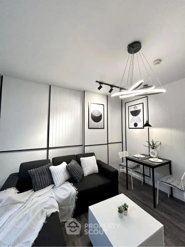 Modern living room with sleek black sofa and stylish decor