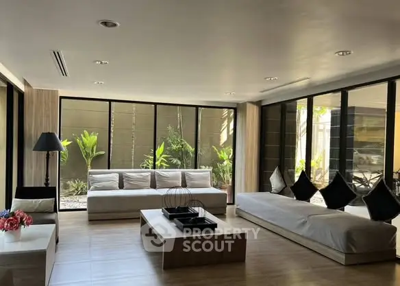 Spacious modern living room with large windows and garden view