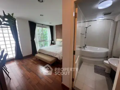 Spacious bedroom with ensuite bathroom featuring modern fixtures and natural light.
