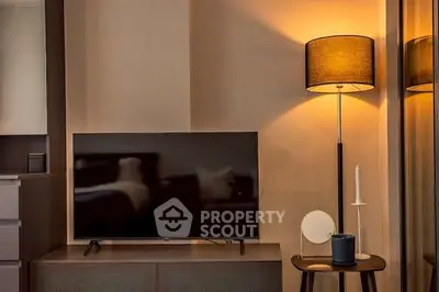 Cozy living room with modern TV setup and stylish floor lamp