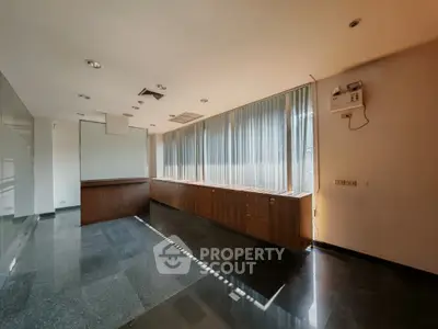 Spacious office space with large windows and ample natural light
