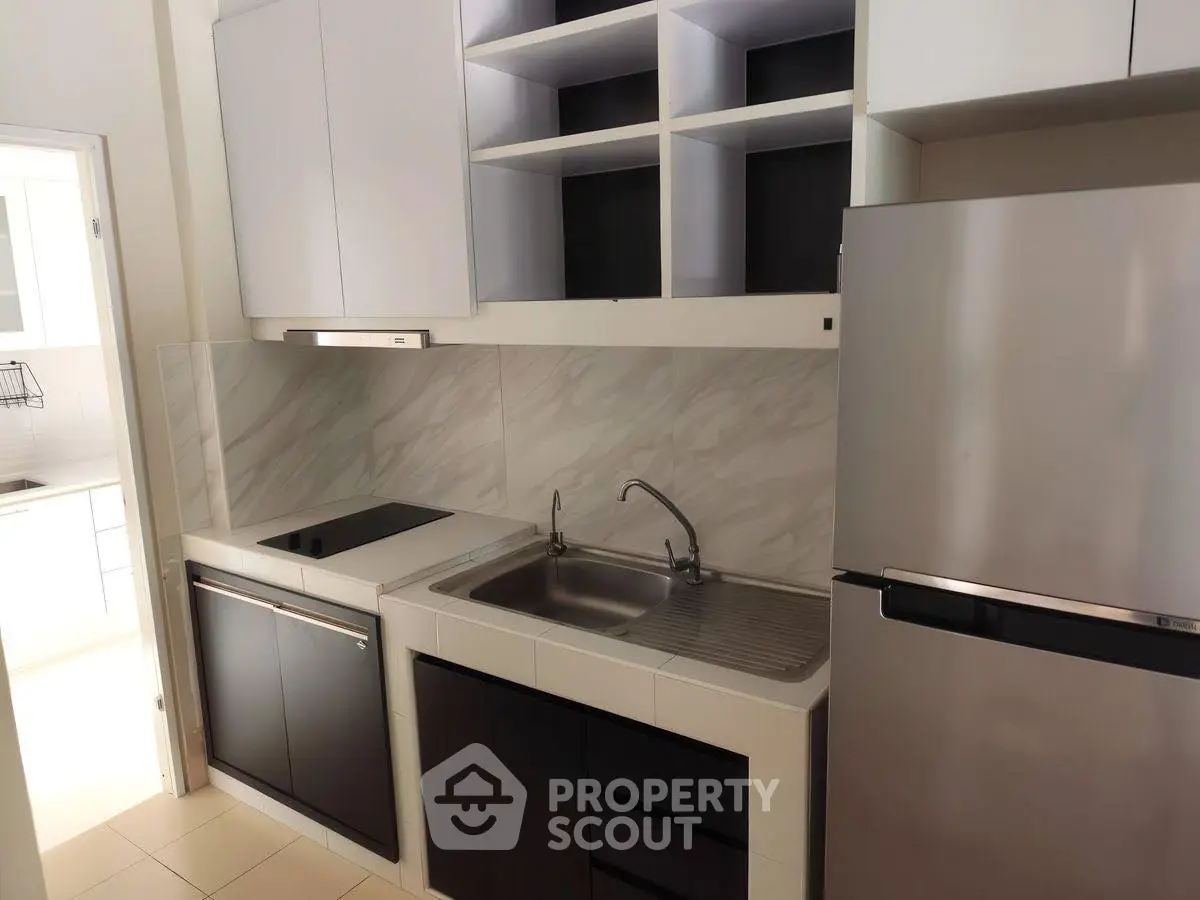 Modern kitchen with sleek appliances and open shelving