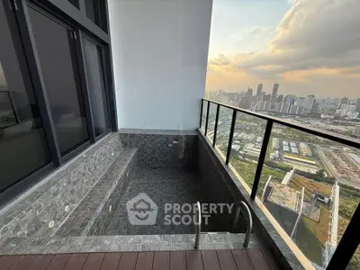 Luxurious high-rise balcony with private plunge pool and stunning city skyline view.